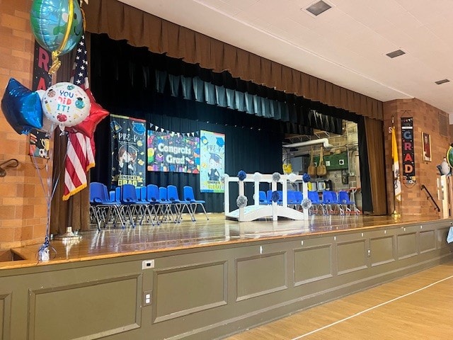 Graduation ceremony stage with balloons and Congrats Grad banners