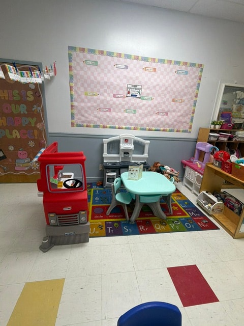 Wantagh classroom with play kitchen and alphabet rug