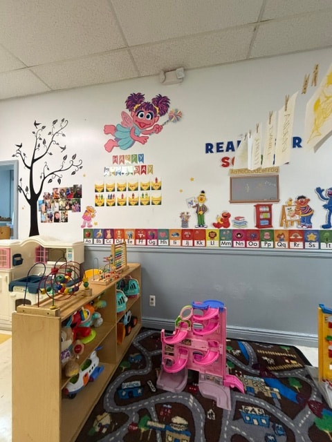 Wantagh classroom with Sesame Street wall decor and toy shelves